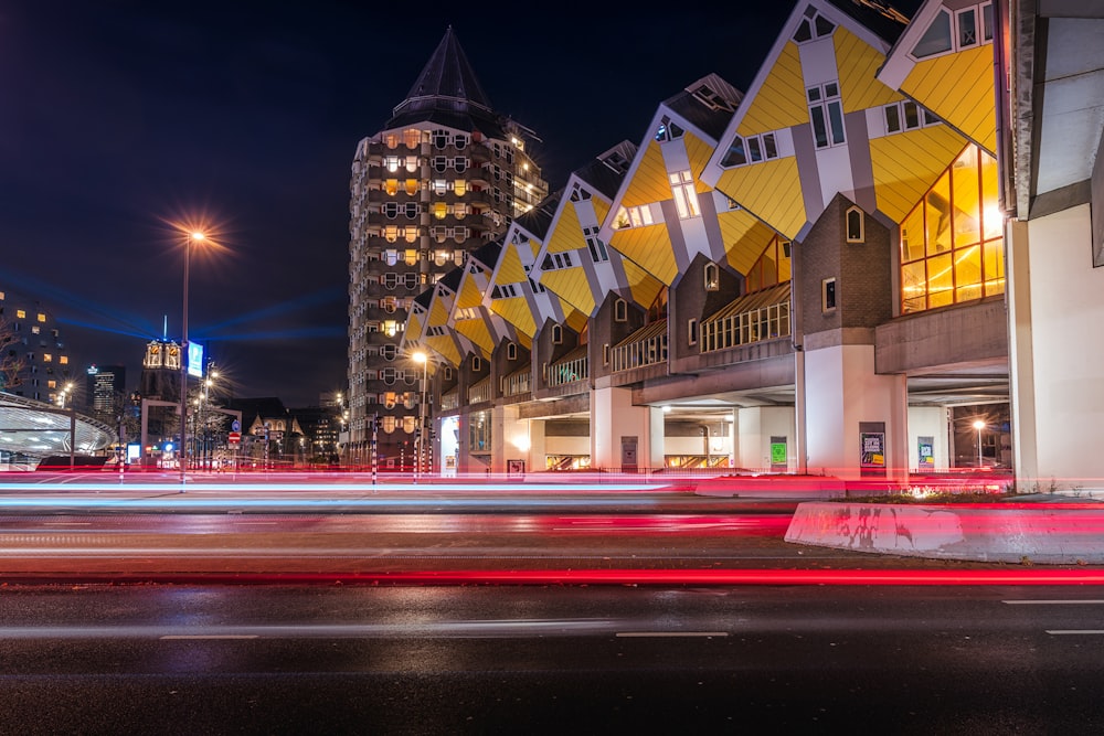 a city street filled with lots of traffic next to tall buildings