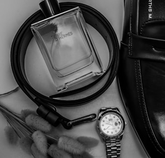 a black and white photo of a watch and a watch strap