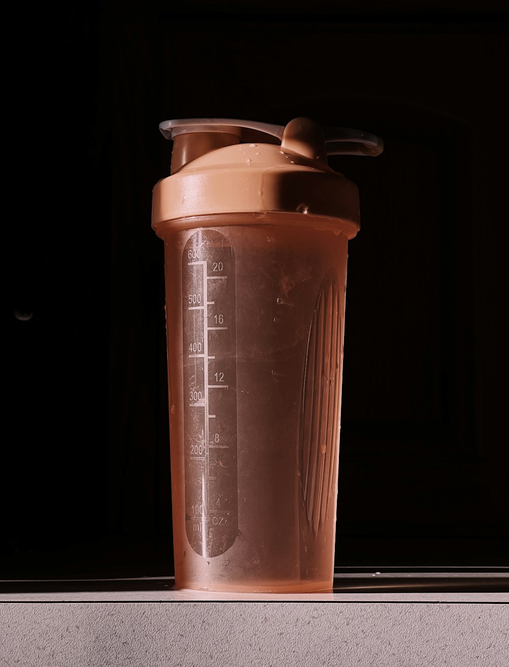 a blender bottle sitting on top of a counter