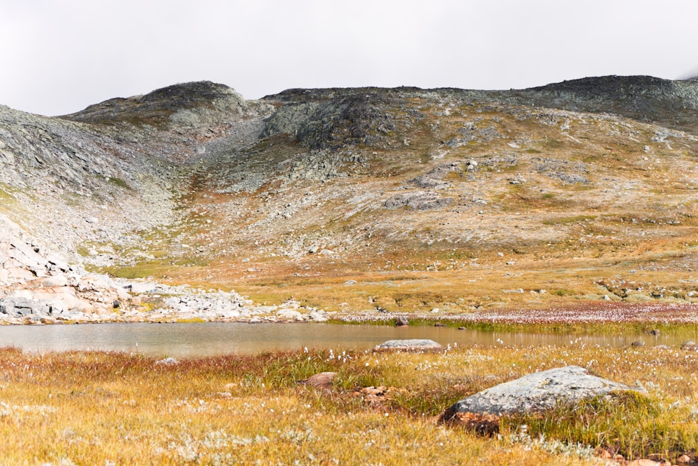 a mountain range with a lake in the foreground