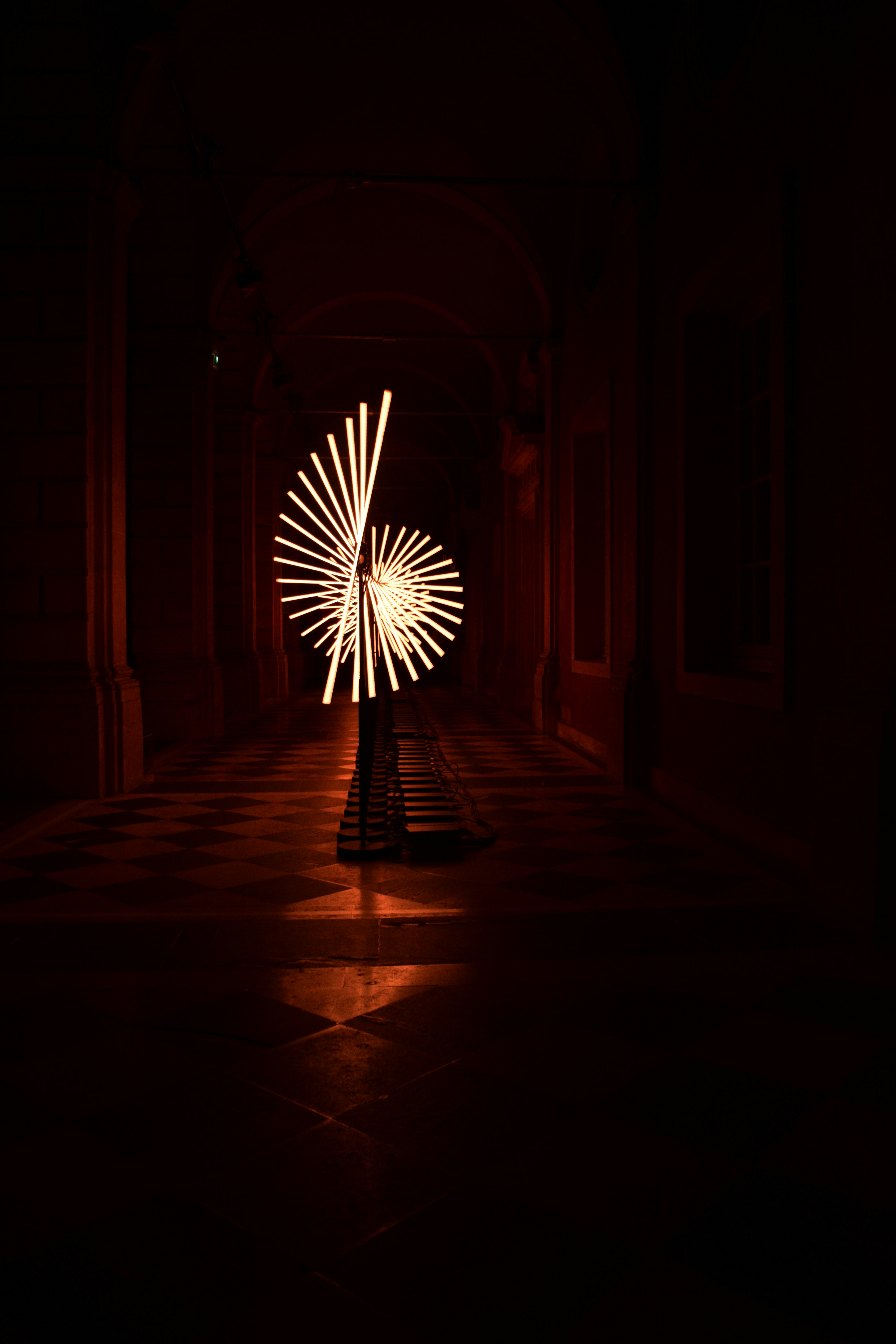 a long exposure photo of a firework in the dark