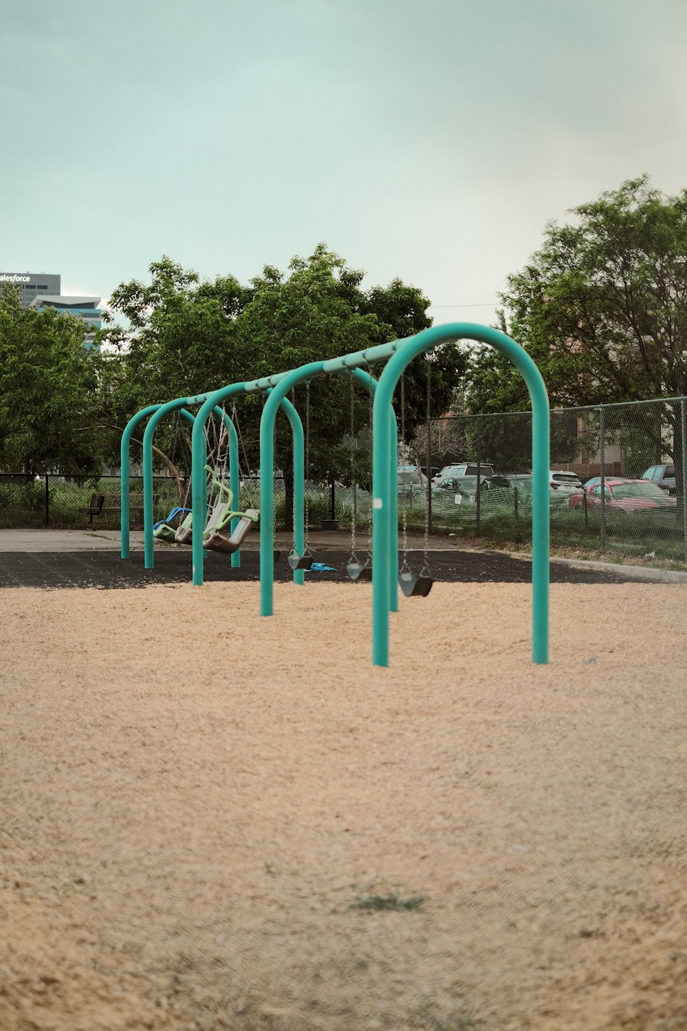 a playground with swings and a slide in a park