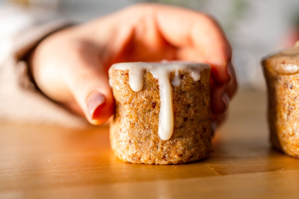 a close up of a person holding a cupcake