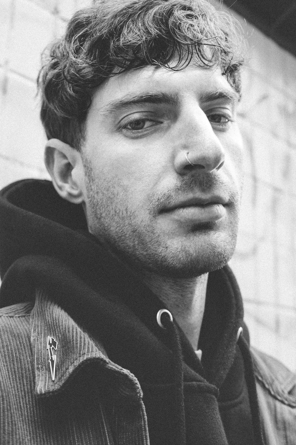 a black and white photo of a man with curly hair