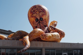 a large statue of an octopus sitting on top of a building