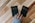 a person holding two small black books with the words buy and sell on them
