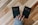 a person holding two small black books with the words buy and sell on them