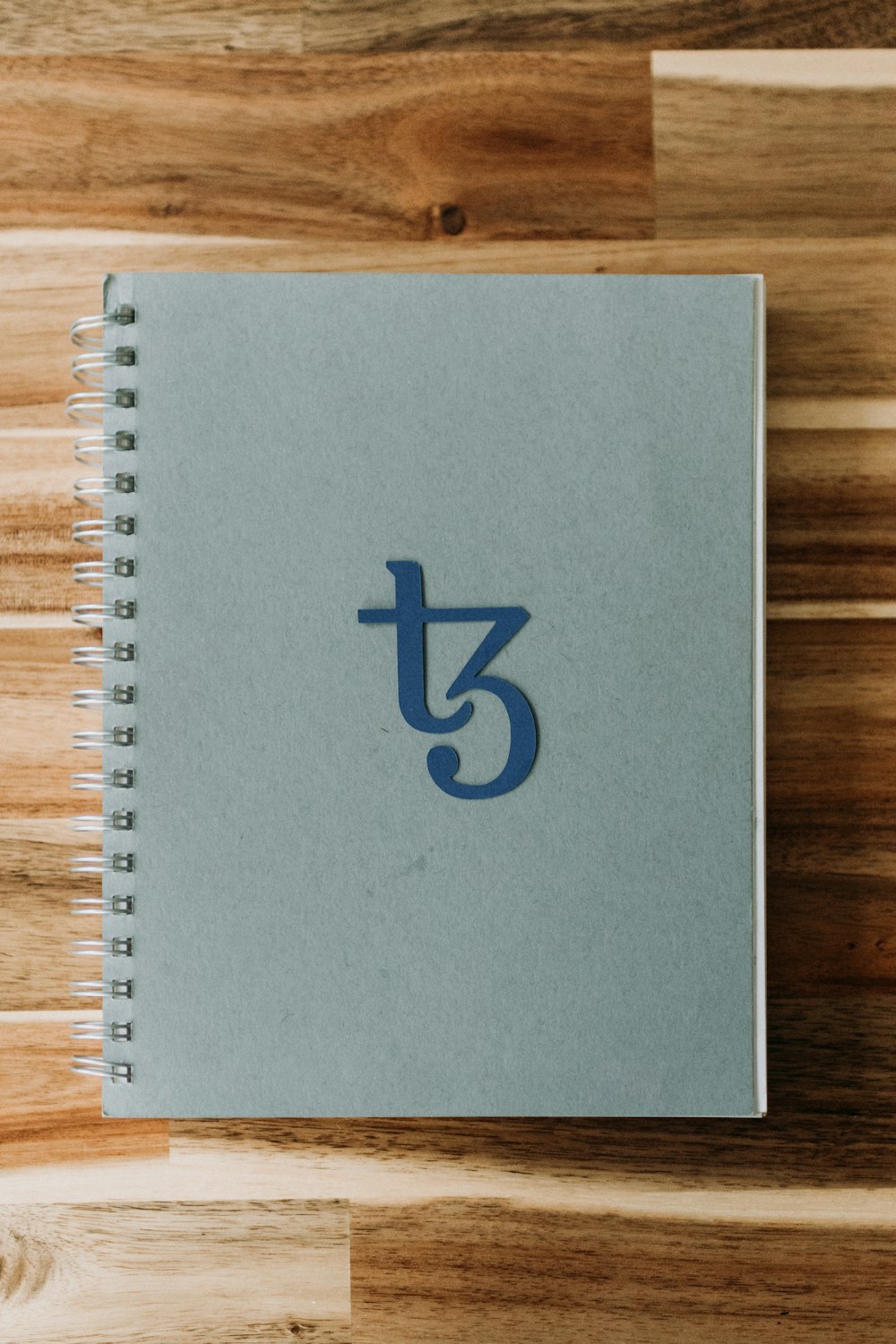 a spiral notebook with the letter j on it