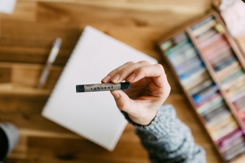 a person holding a pen in their hand