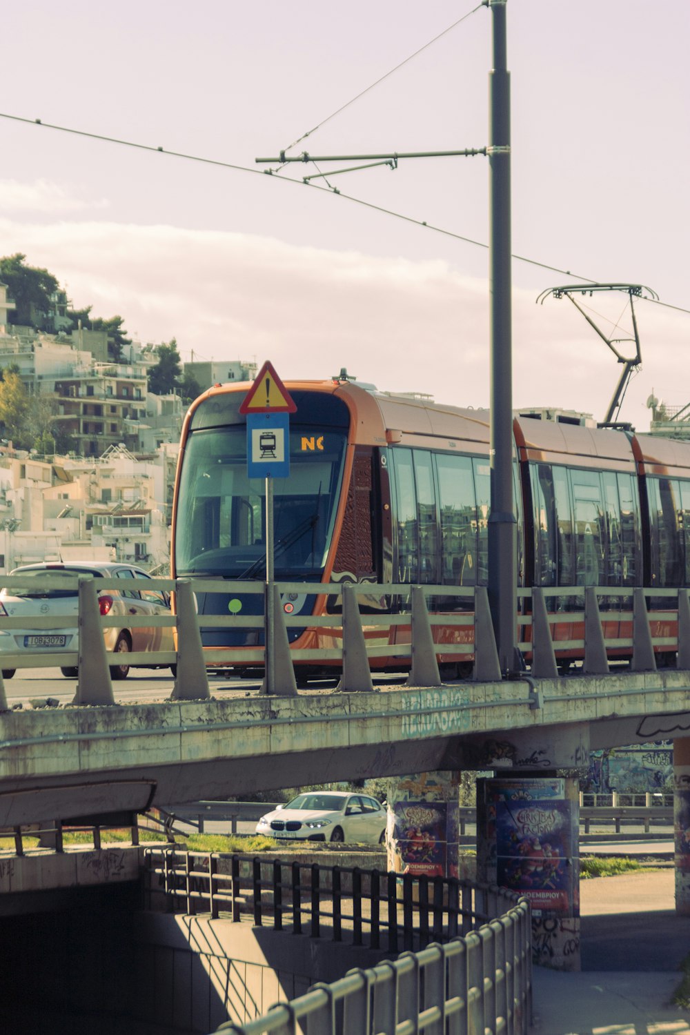 a train traveling over a bridge over a street