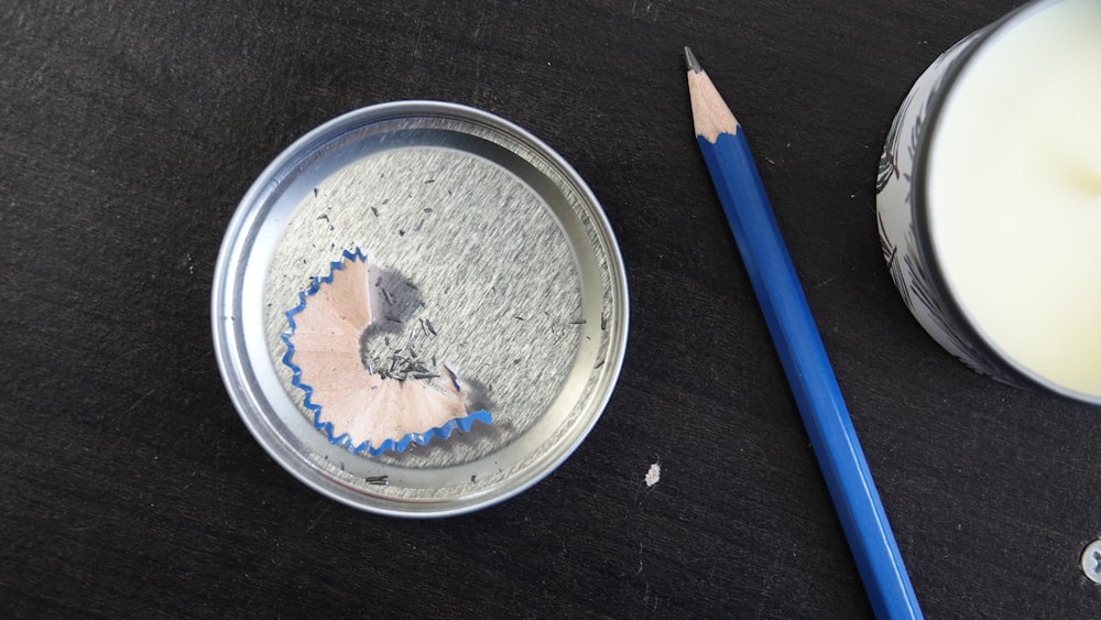 a cupcake tin with a pencil next to it