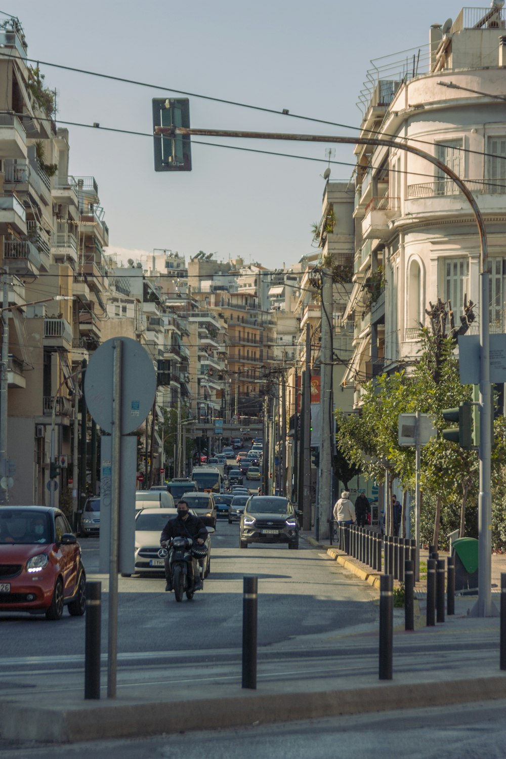 a city street filled with lots of traffic next to tall buildings