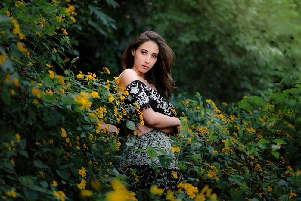 a woman standing in a field of yellow flowers