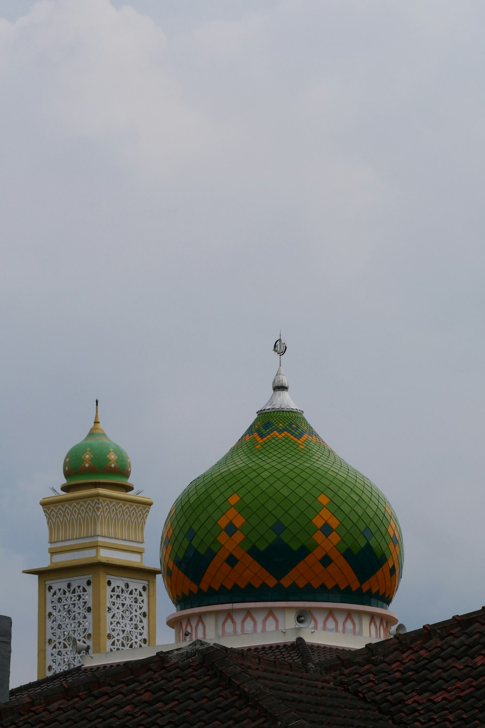 a green and yellow dome on top of a building