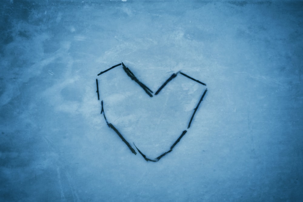a heart drawn in the snow on a cold day