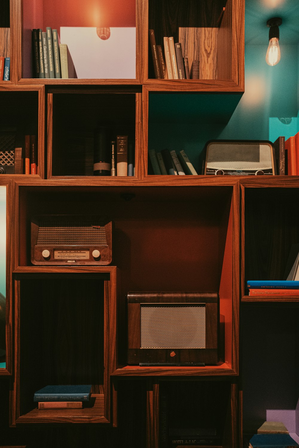 a wooden shelf with a radio and books on it