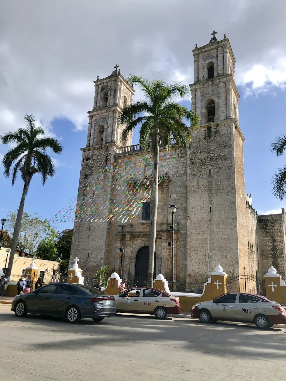 a large church with a tall tower with a clock on it's side