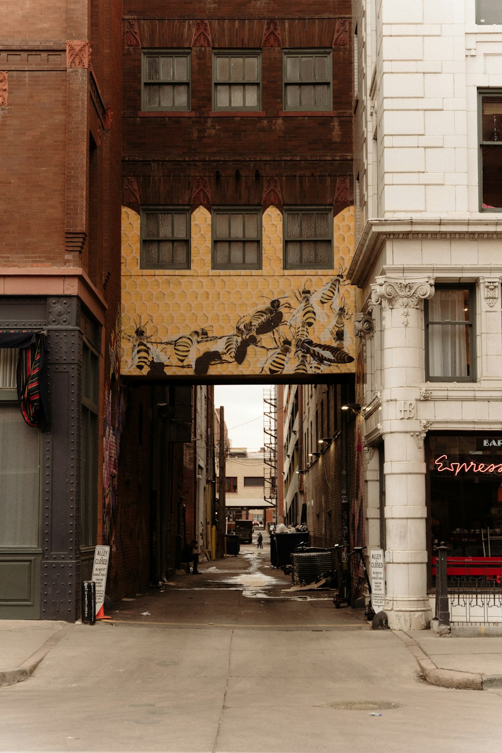 a narrow city street with a few buildings