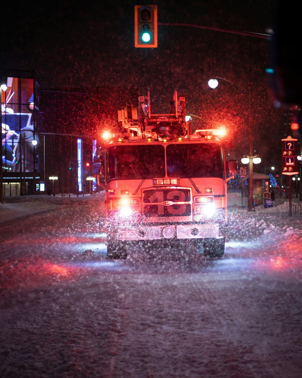 a fire truck driving down a street at night