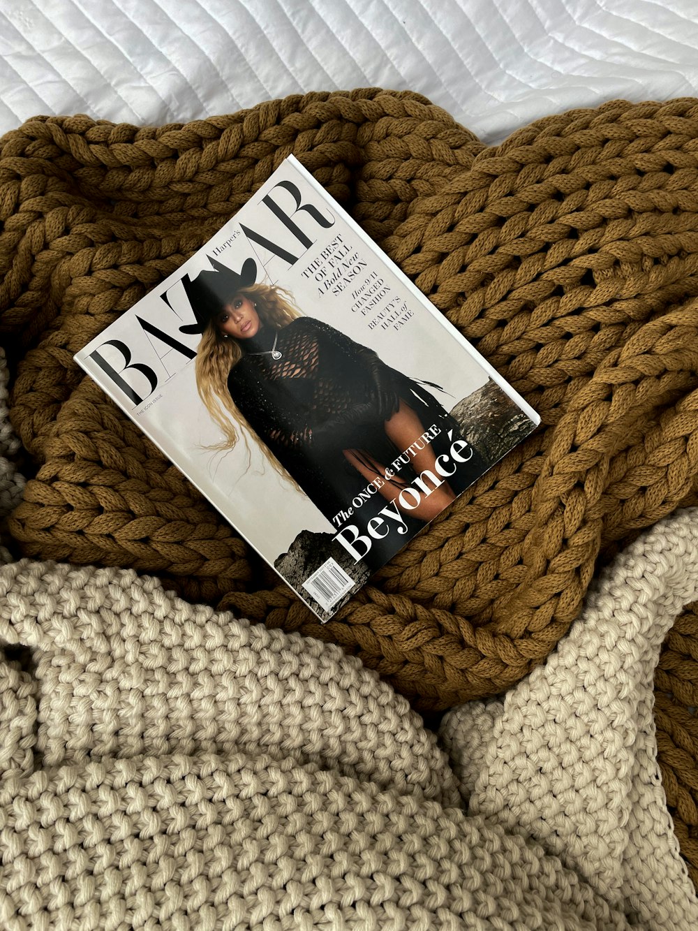 a magazine laying on top of a pile of blankets