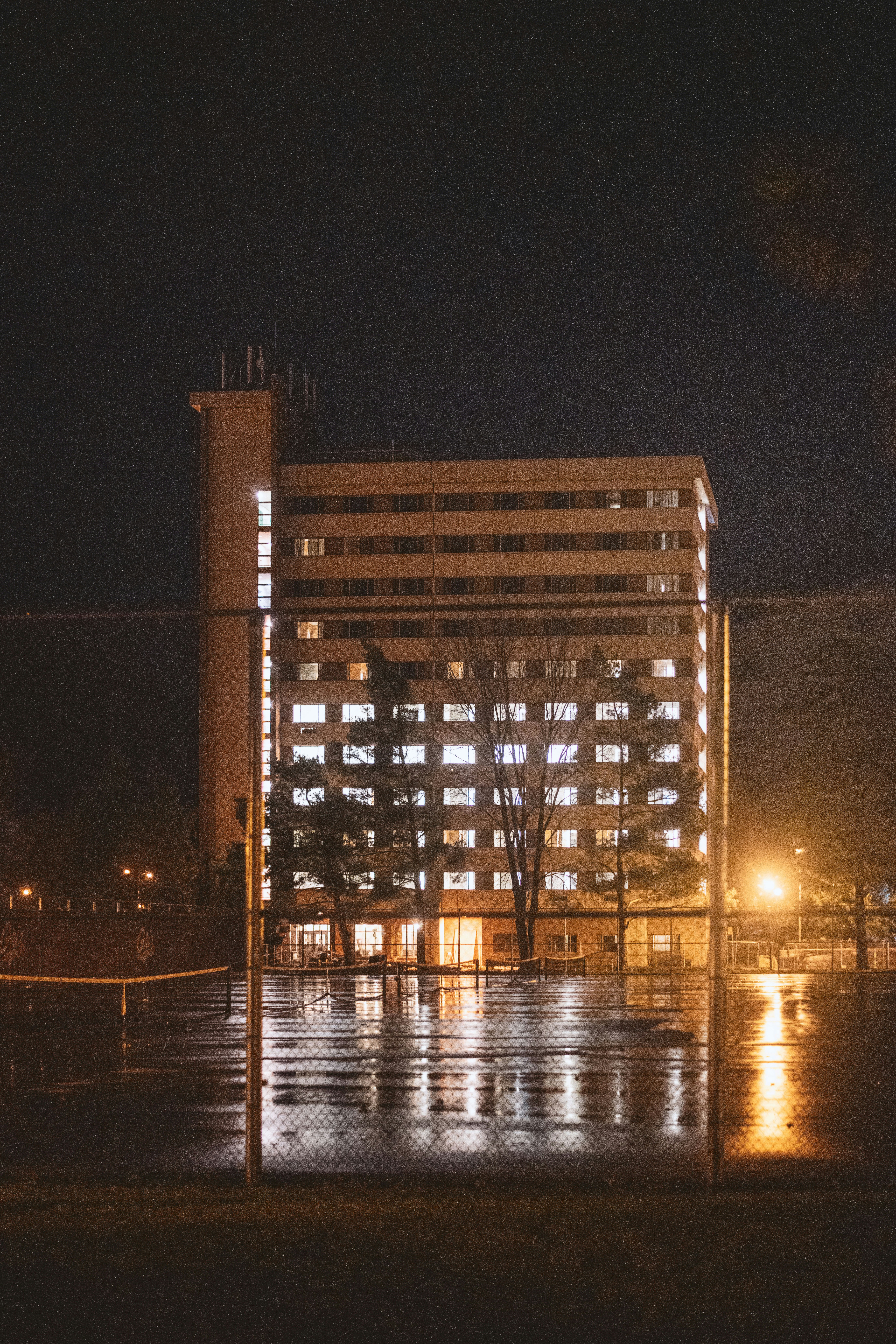 a tall building with a clock tower at night