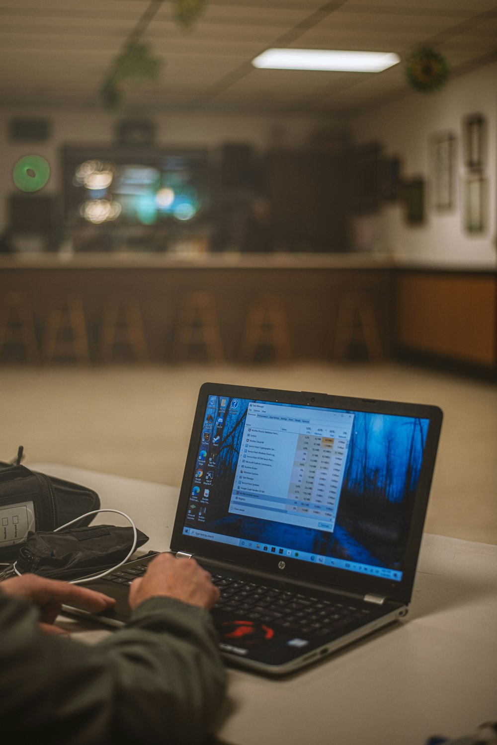 a man sitting at a table using a laptop computer