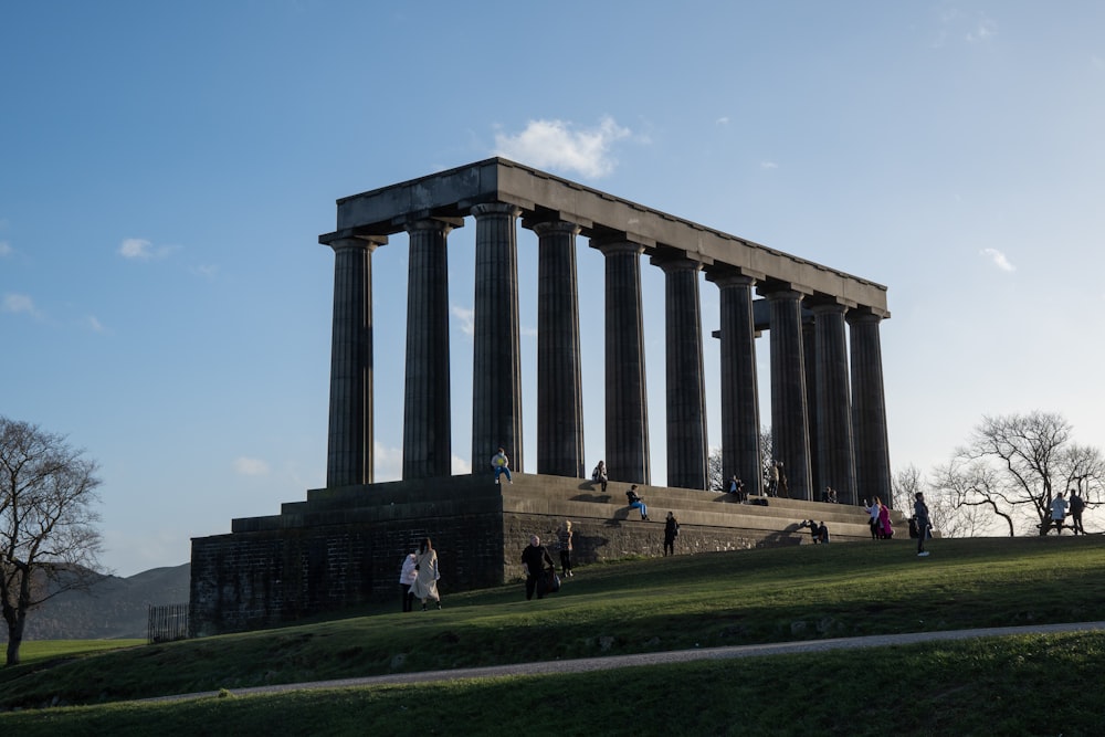 a group of people standing in front of a monument