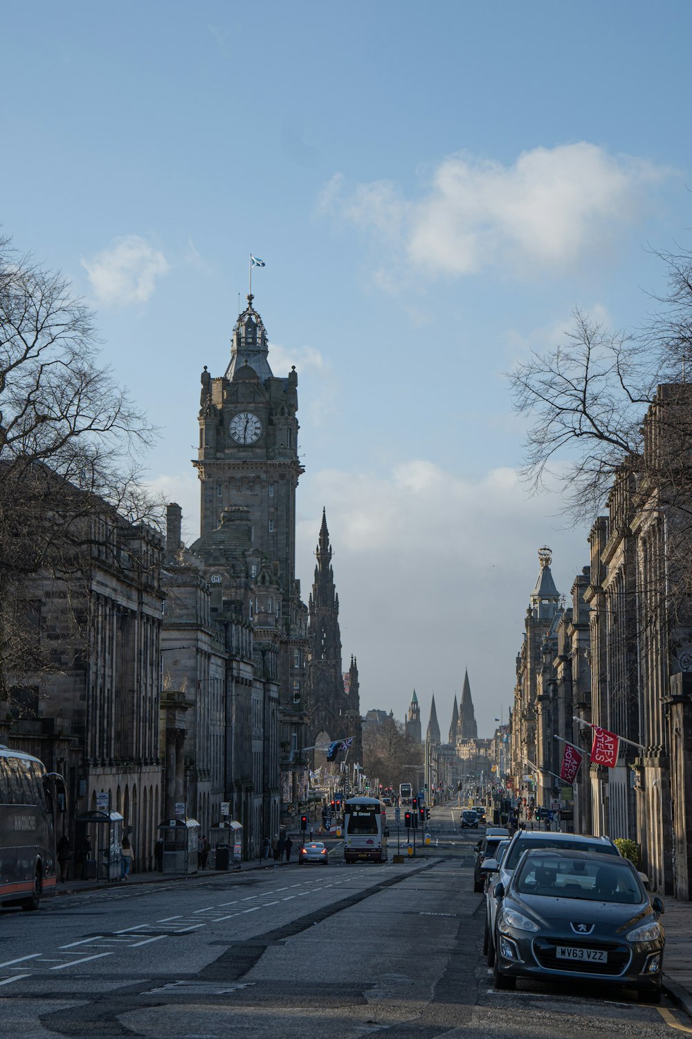 a city street with a clock tower in the background