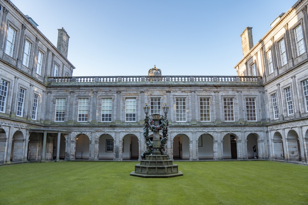 a large building with a fountain in the middle of it