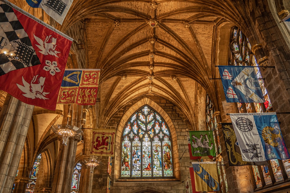 a large cathedral with flags hanging from the ceiling