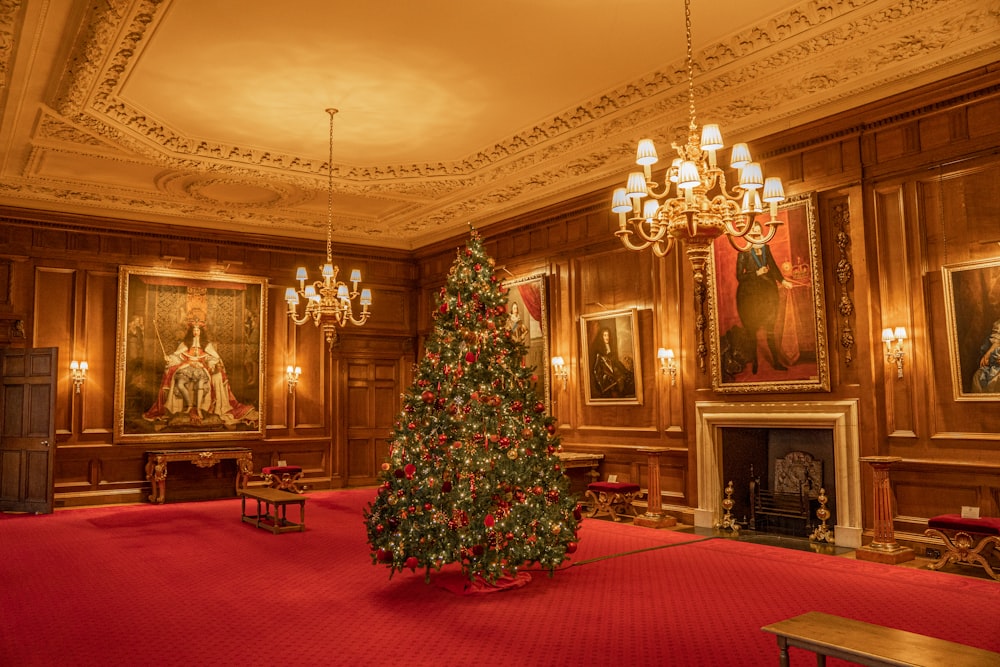 a christmas tree in a large room with chandeliers