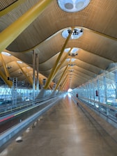 an empty airport terminal with a long walkway