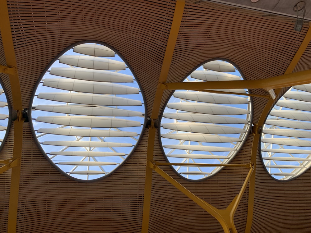 three round windows in the ceiling of a building