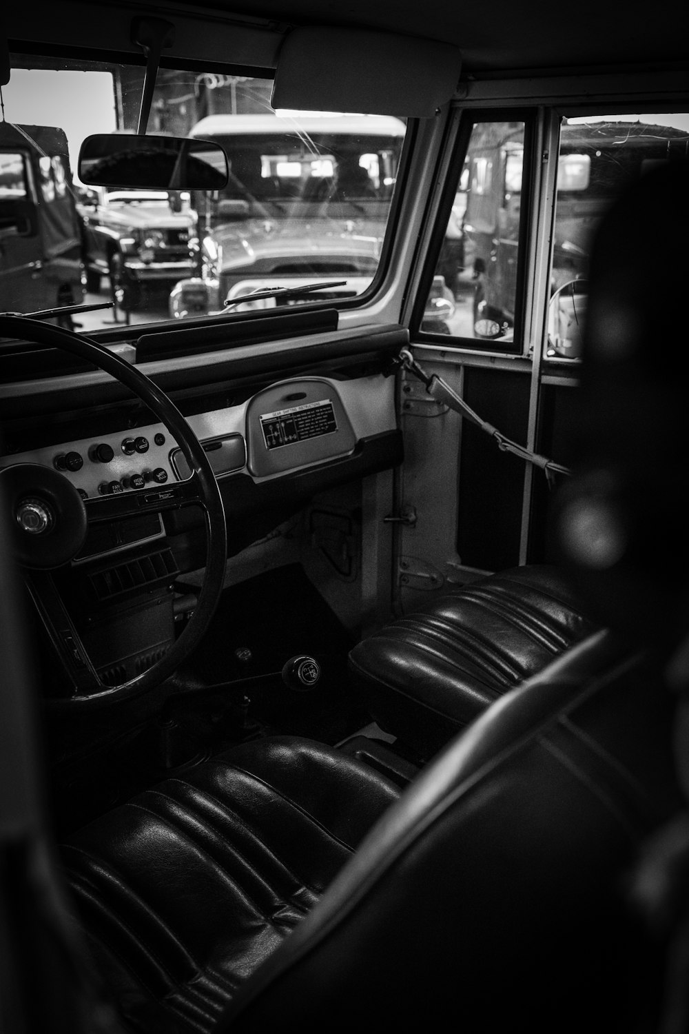 a black and white photo of a car interior