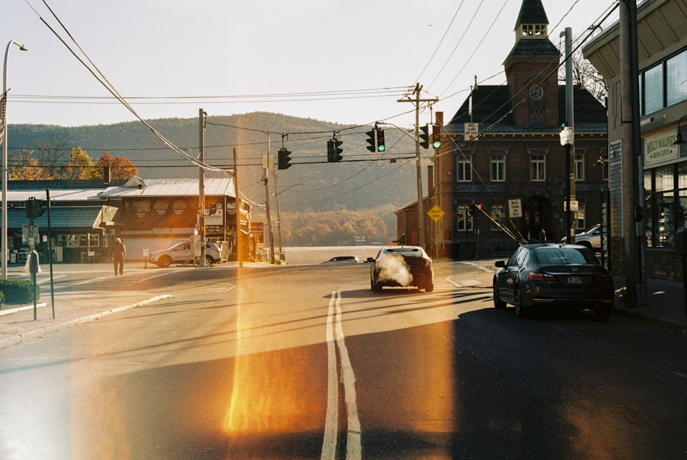 a car driving down a street next to a traffic light