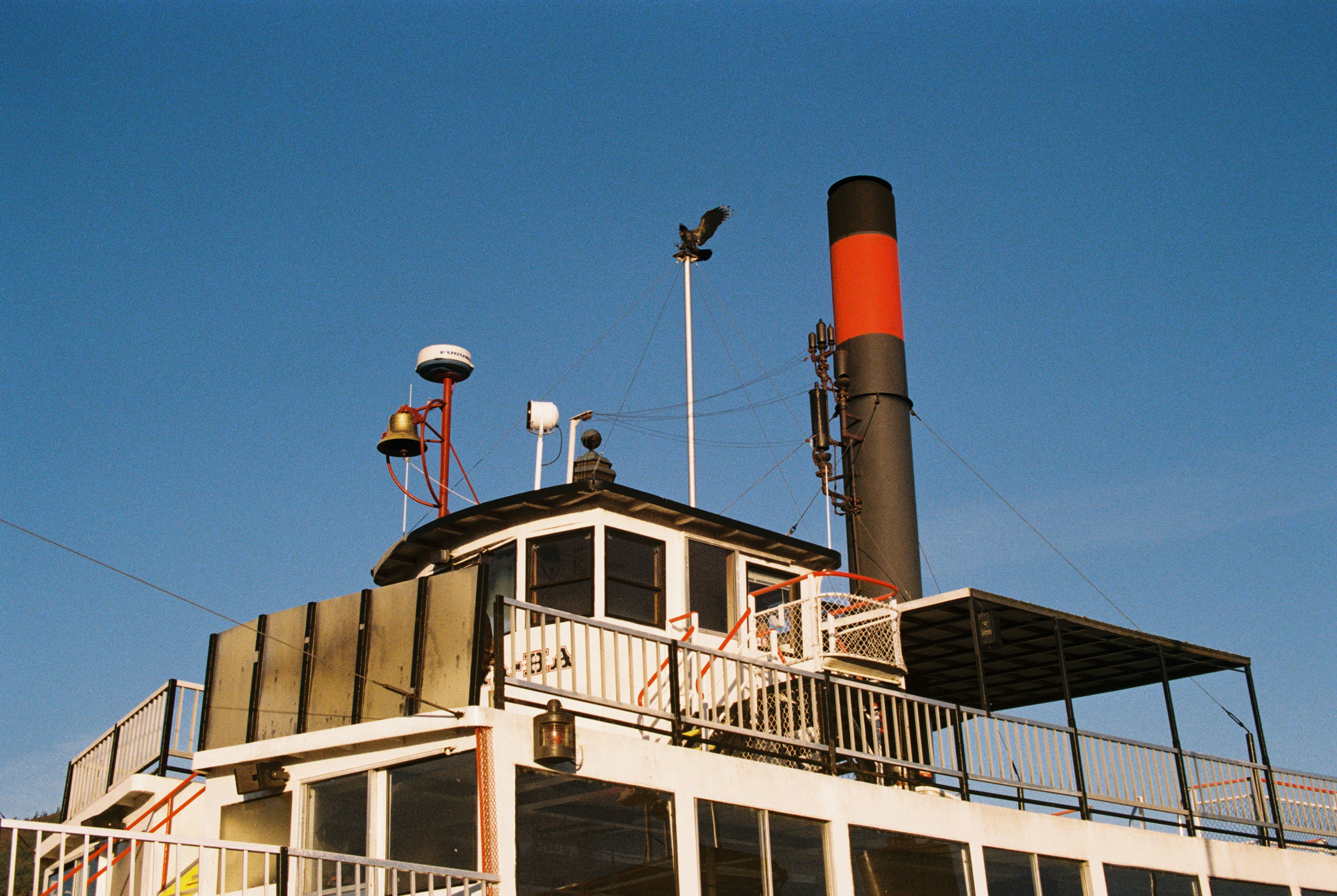 a large building with a red and black chimney on top of it