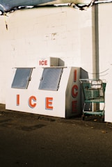 an ice cream stand with a shopping cart in front of it