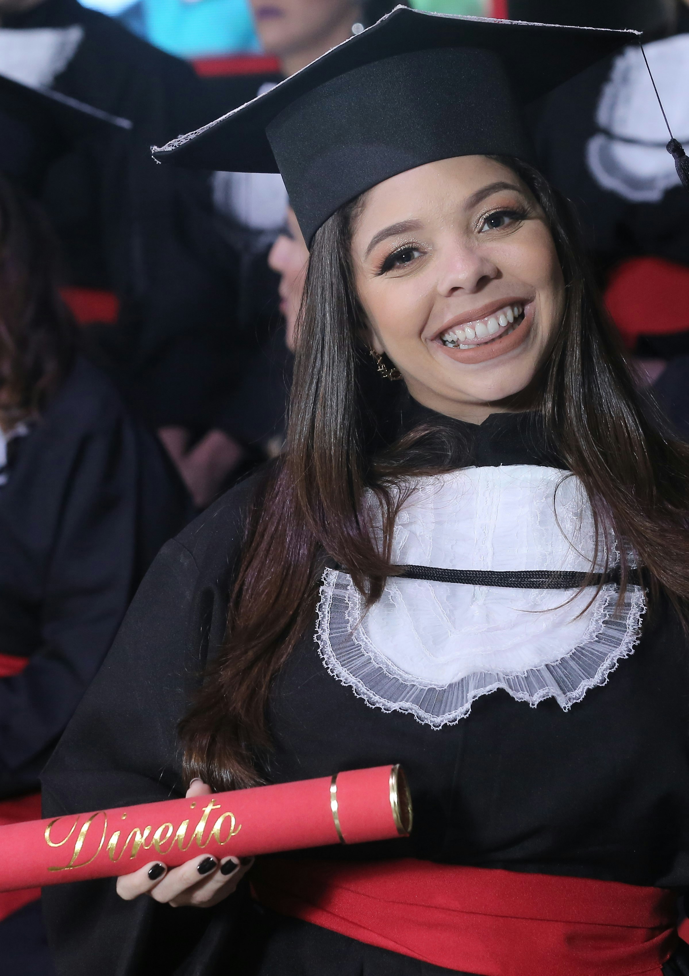a-woman-in-a-graduation-gown-holding-a-diploma-photo-free-graduation