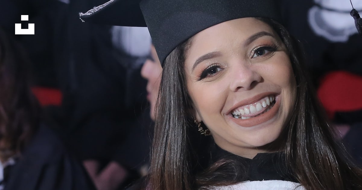 A Woman In A Graduation Gown Holding A Diploma Photo Free Graduation a-woman-in-a-graduation-gown-holding-a-diploma-photo-free-graduation