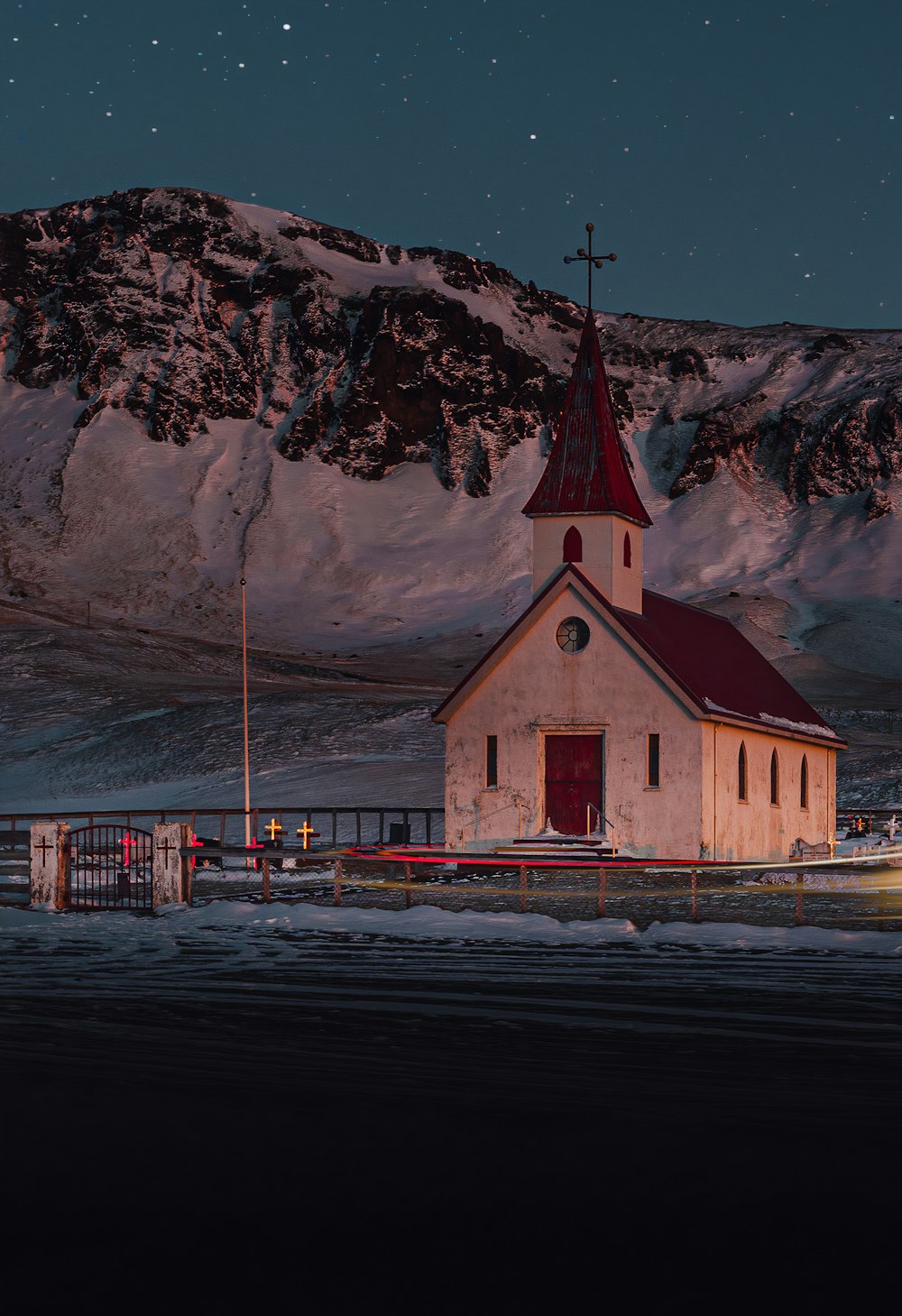 a church in the middle of a snowy field