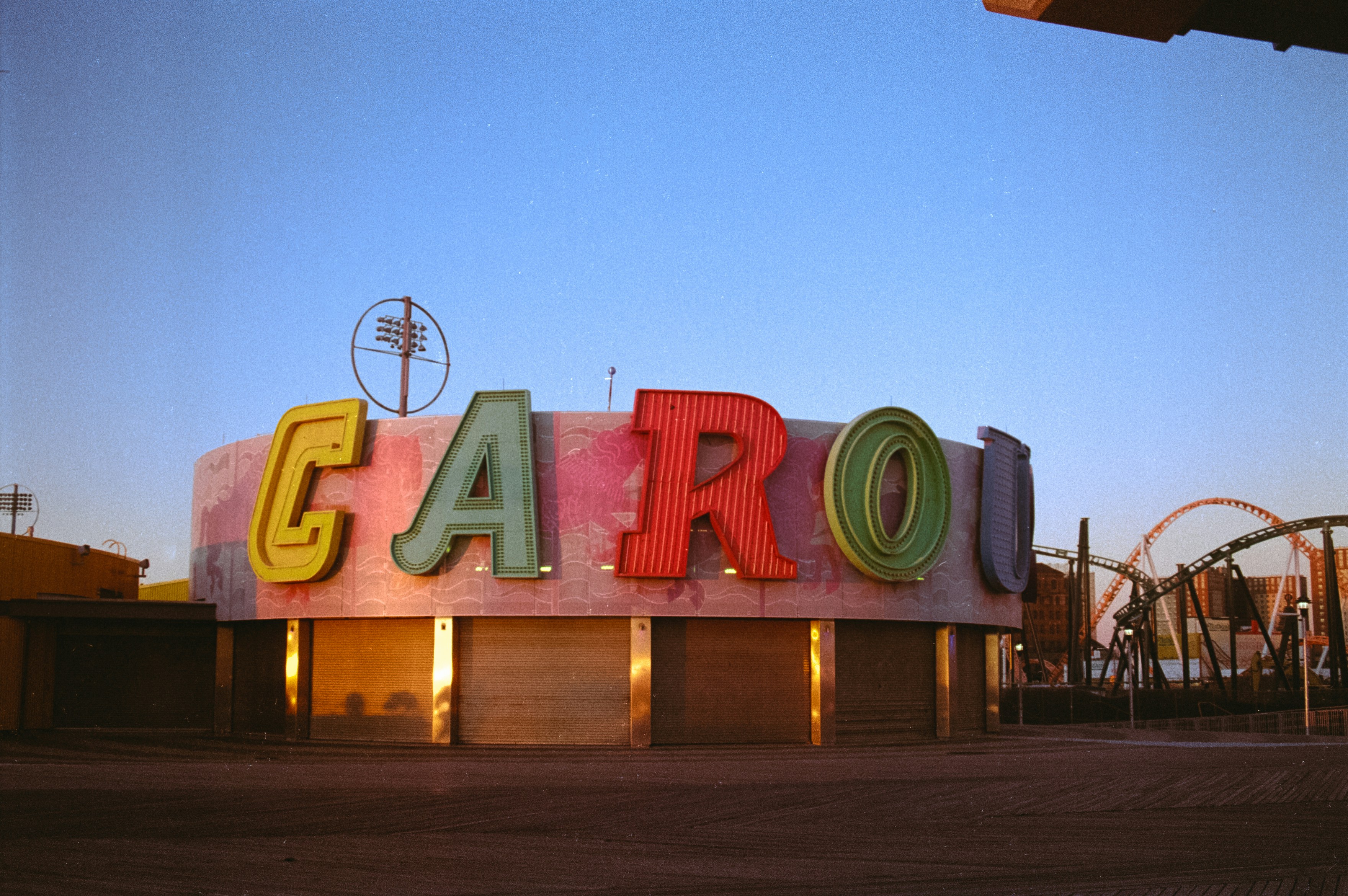 a sign that says garo in front of a roller coaster