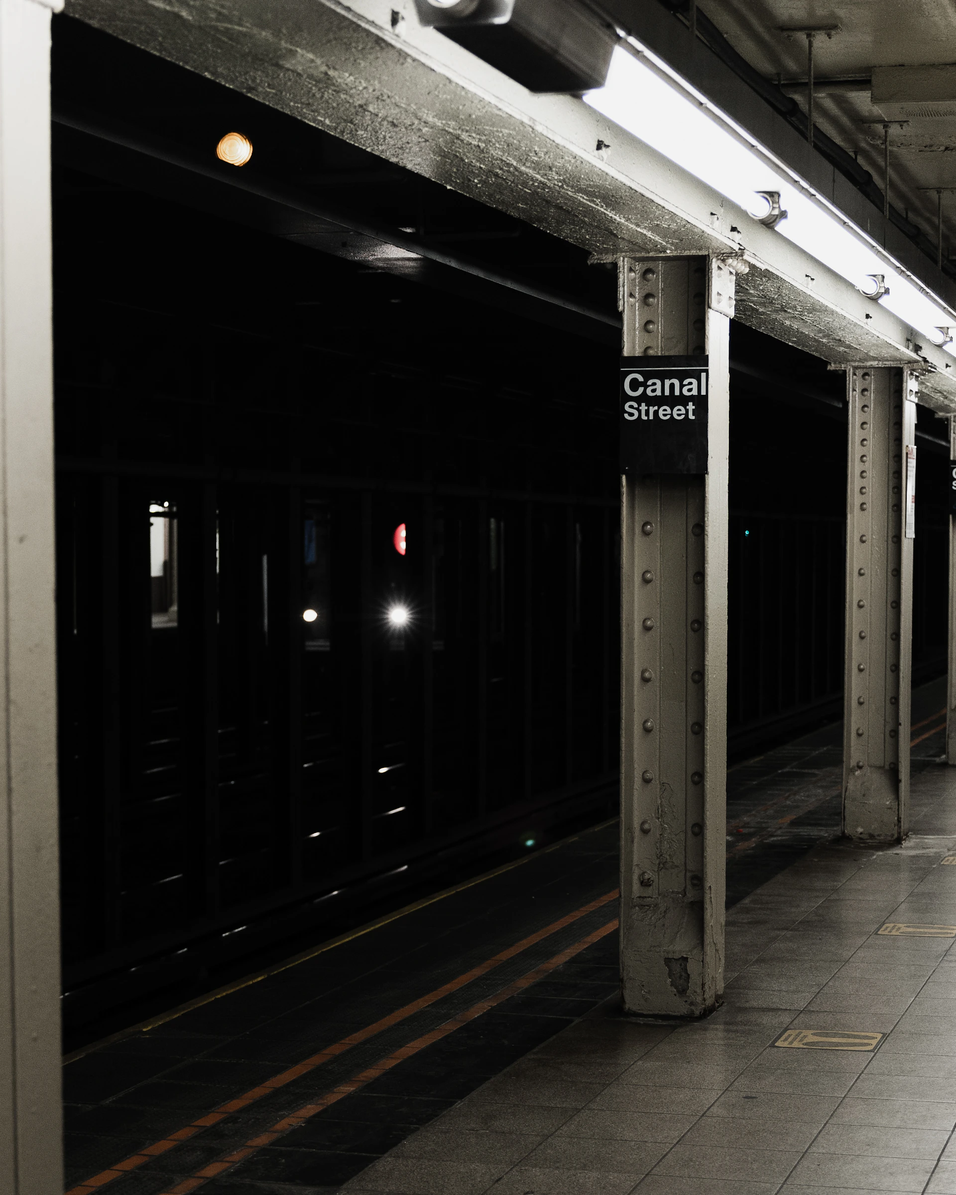 a black and white photo of a subway station