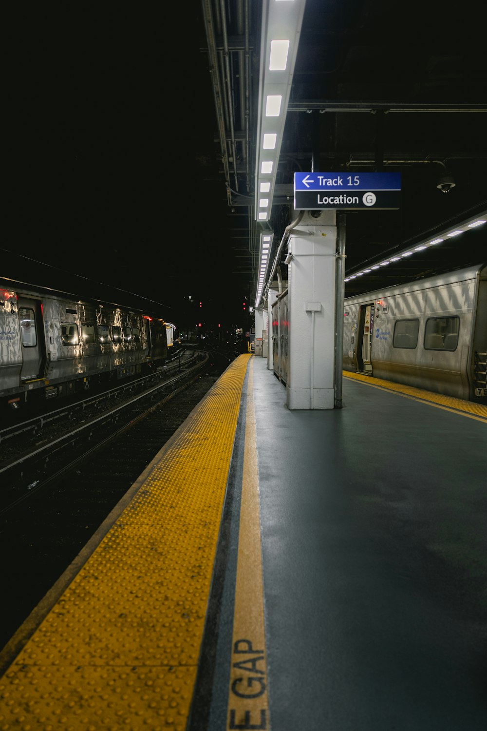 a train pulling into a train station next to a platform