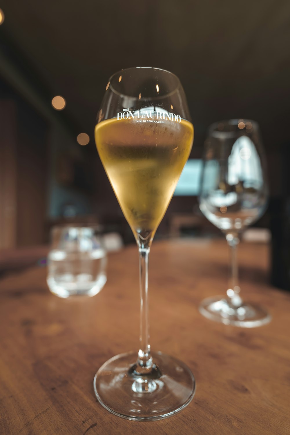 a close up of a wine glass on a table