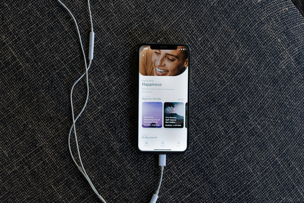 a cell phone plugged into a charger on a couch