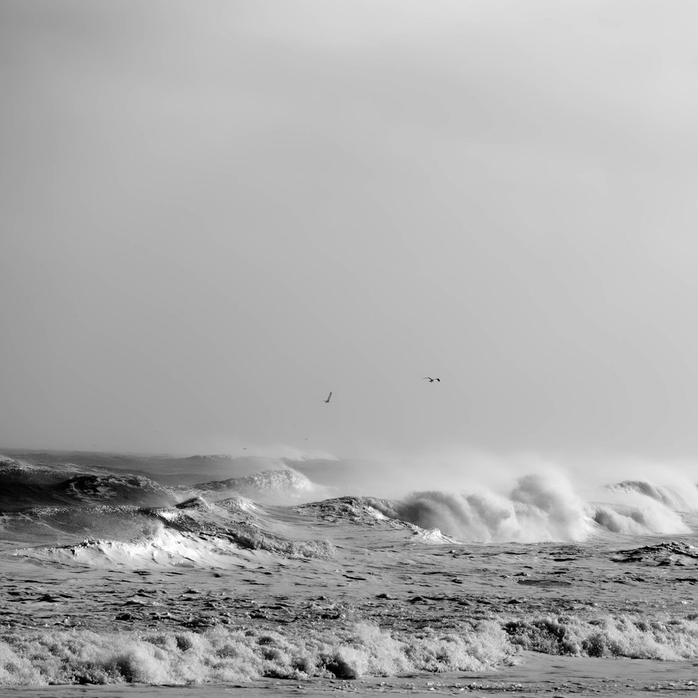 a black and white photo of the ocean waves