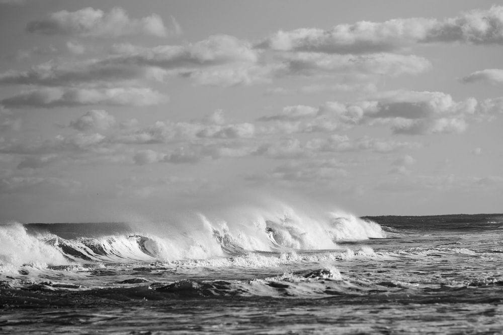 a black and white photo of a large wave
