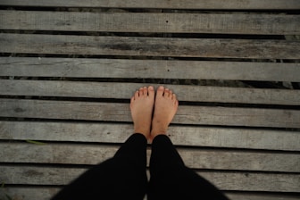 a person standing on top of a wooden bench