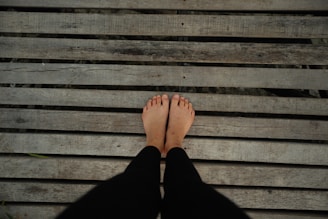 a person standing on top of a wooden bench