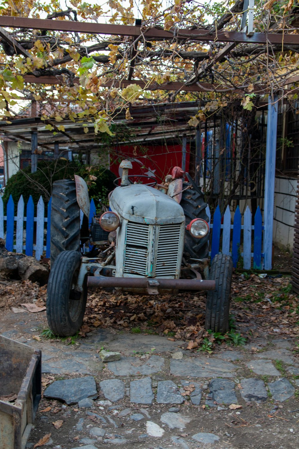 an old tractor is parked in front of a house